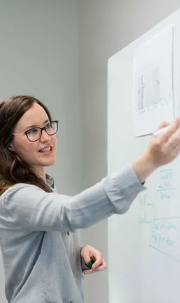 woman working on a web design on a white board